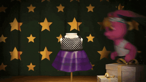 a pink bunny doll is standing in front of a green curtain with gold stars