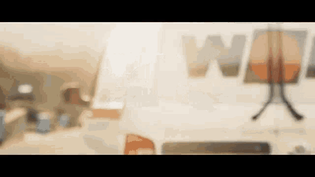 a blurred image of a white van with the word wm on the back .