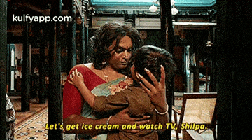 a woman is holding a child in her arms in a room .
