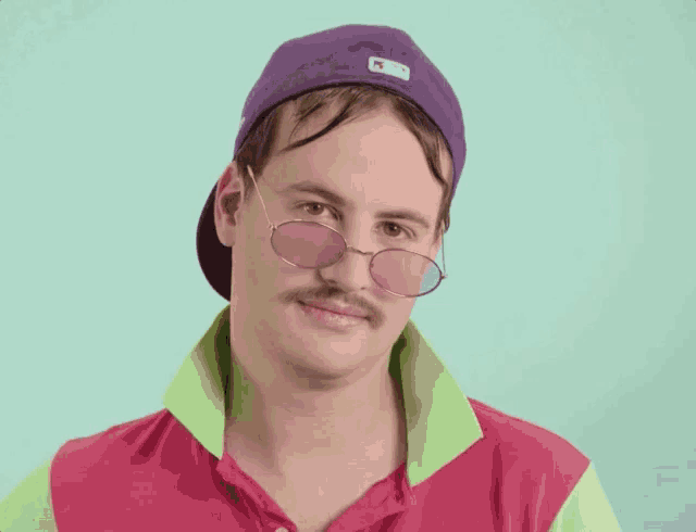 a man wearing sunglasses and a purple hat with the letter m on it