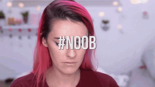 a woman with red hair has the hashtag #noob on her eye
