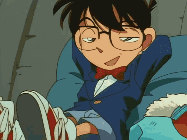 a cartoon character with glasses and a bow tie is sitting on a chair