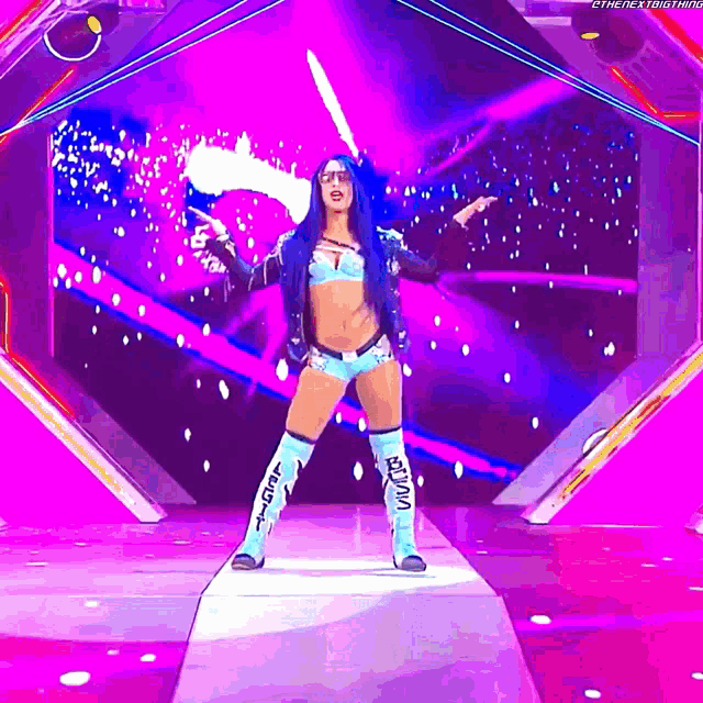 a female wrestler is walking down a runway with a purple background and the letters s on her boots