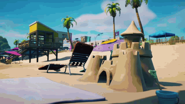 a sand castle sits on a beach next to a chair and bucket