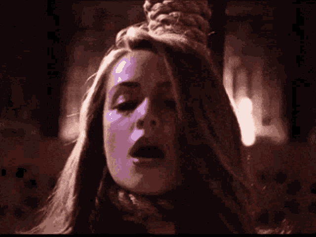 a purple flame is coming out of a circular object in a dark room