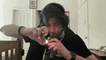 a man lighting a bottle with a lighter