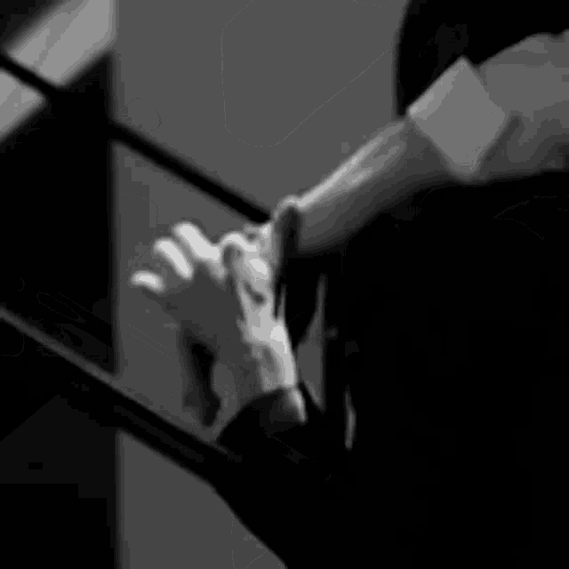 a black and white photo of a woman sitting on a staircase
