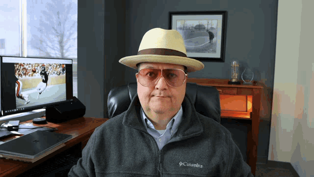 a man wearing a columbia jacket and a hat