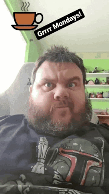 a man with a beard is wearing a star wars shirt and says grrr mondays