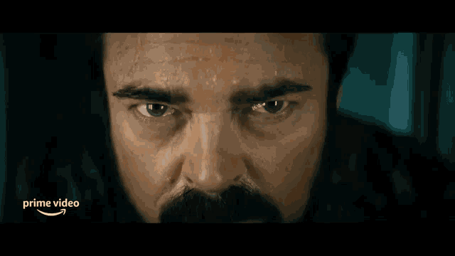 a close up of a man 's face with glowing eyes and a prime video logo in the corner