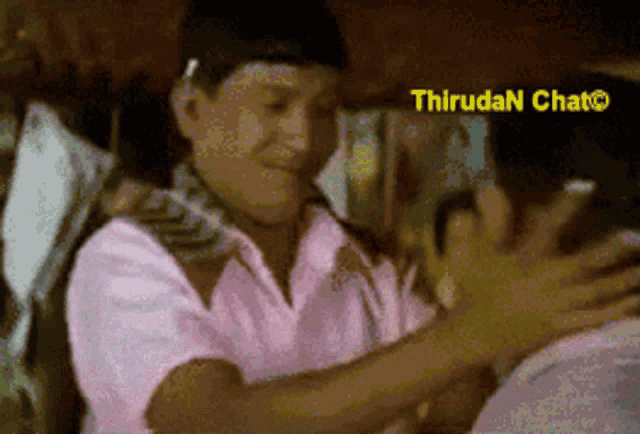 a blurred image of two people with thirudan chat written in the upper right corner