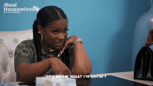 a woman sitting at a table with the words " you know what i 'm sayin ' "