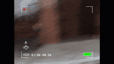a recording of a person walking down a street with a red rec button