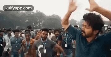 a man is dancing in a crowd of people .