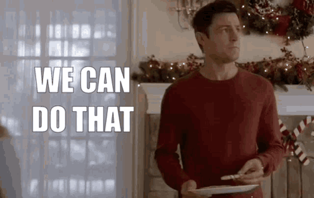 a man in a red sweater is holding a plate of food in his hands .