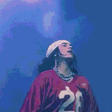 a woman wearing a red jersey with the number 20 on it is standing on a stage .