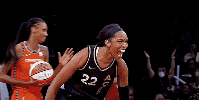 a female basketball player with the number 22 on her jersey is celebrating