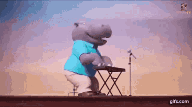 a hippopotamus is playing a keyboard and singing into a microphone