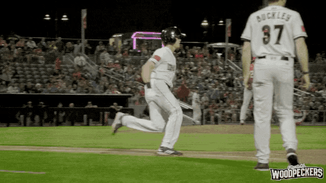 a baseball player with the number 37 on his jersey is running