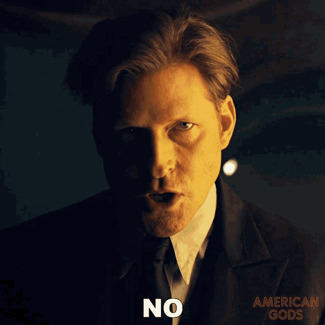 a poster for american gods shows a man in a suit and tie