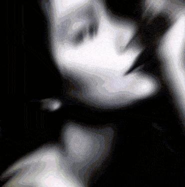 a black and white photo of a woman 's face with a pearl earring