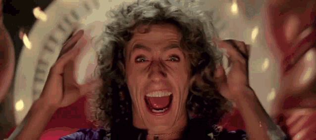 a man with curly hair is making a funny face .