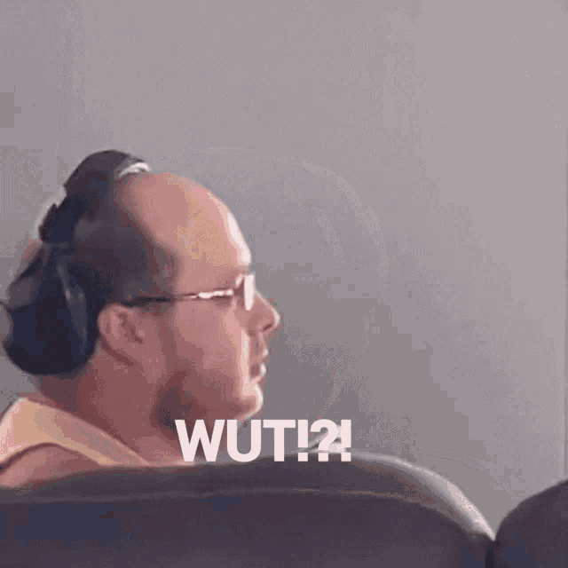 a man wearing headphones says " wut " in white letters