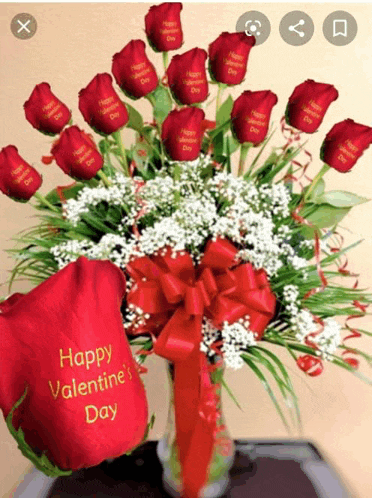 a happy valentine 's day pillow sits next to a vase of roses