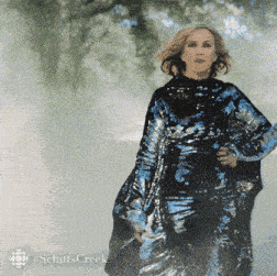 a woman in a sequined dress with the word schitts creek on the bottom left