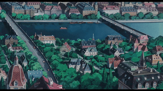 an aerial view of a city with a river and a bridge