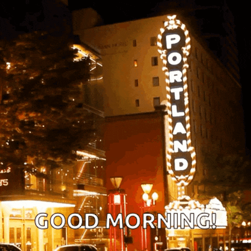 a sign for portland is lit up at night and says good morning