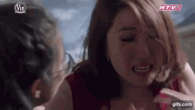 a woman is crying while a man holds her breast .
