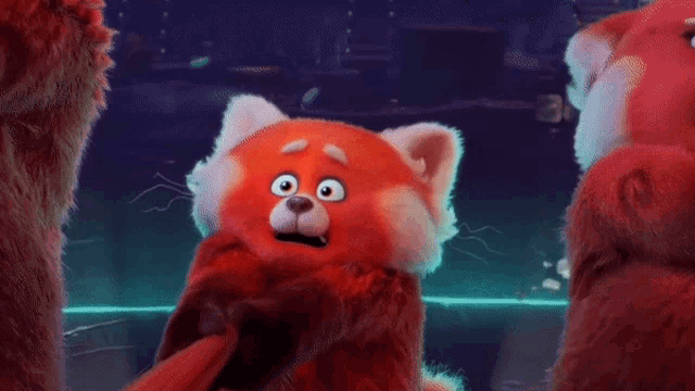 a red teddy bear is making a surprised face