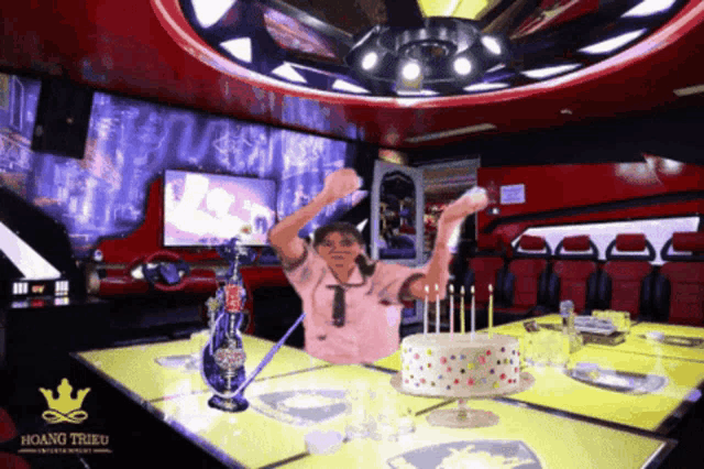 a table with a birthday cake and a bottle of coca cola on it