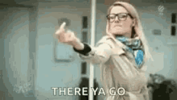 a woman in a trench coat is giving the middle finger .