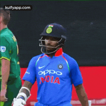 a man wearing a helmet and a blue shirt with the word india on it
