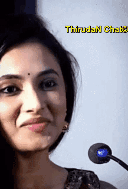 a close up of a woman 's face with the word thirudan written above it