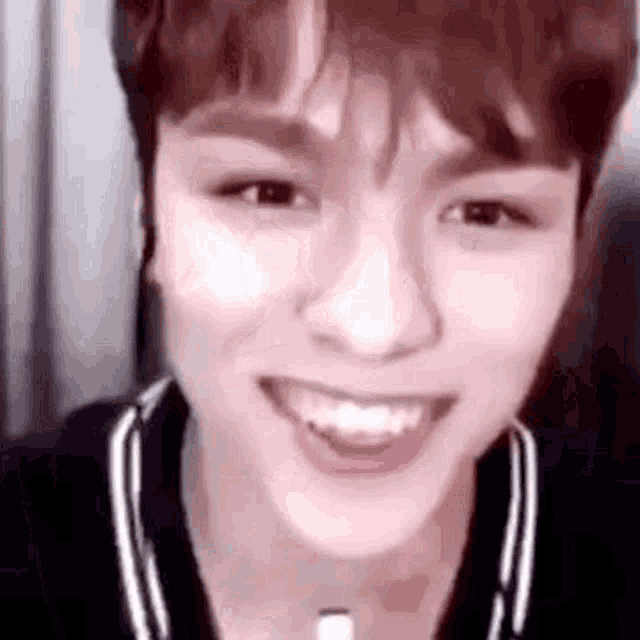 a close up of a person 's face while smiling .