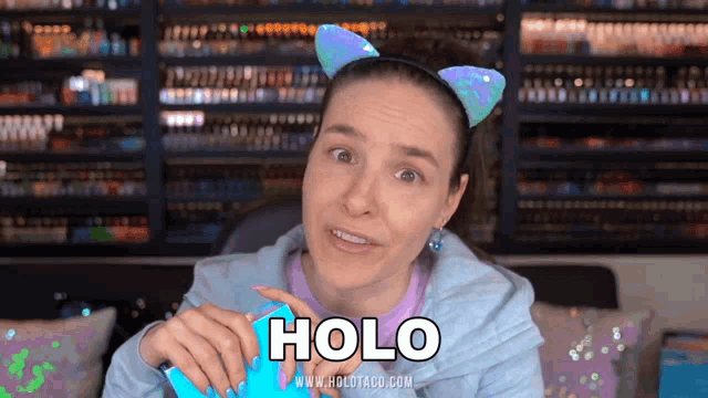 a woman wearing a cat ear headband says holo