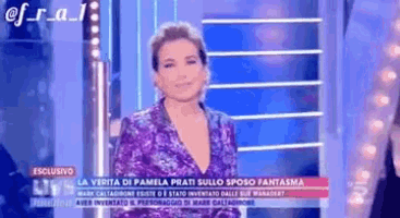 a woman in a purple dress is standing on a stage in front of a screen .