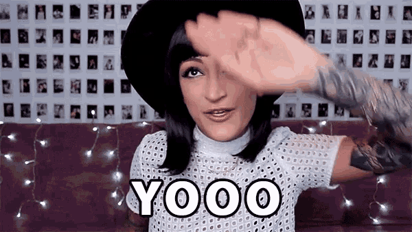 a woman covering her face with her hand with the word yooo written on it