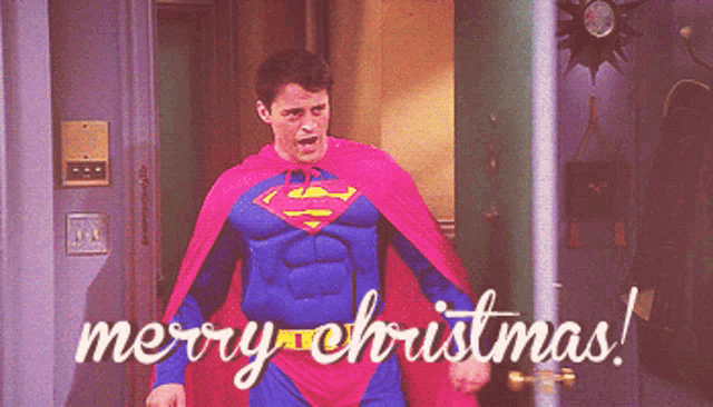 a man in a superman costume with the words merry christmas