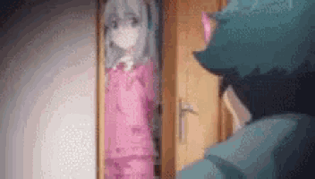 a man is standing in front of a door looking at a girl in a pink outfit .