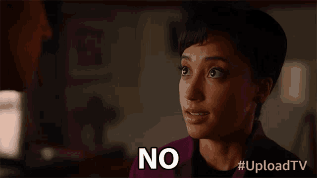 a woman in a purple jacket is saying " no "