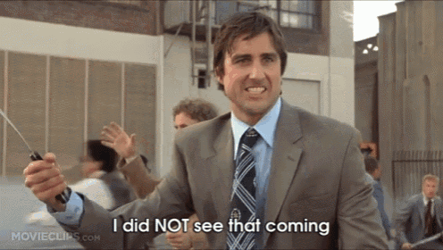 a man in a suit and tie is holding a stick and says i did not see that coming
