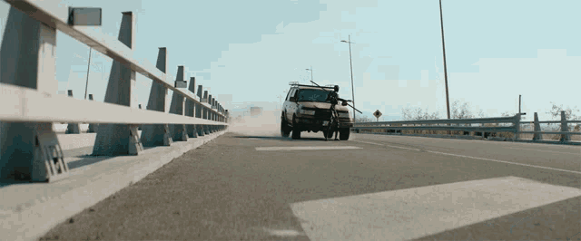 a car is driving down a highway with a yellow sign that says ' a ' on it
