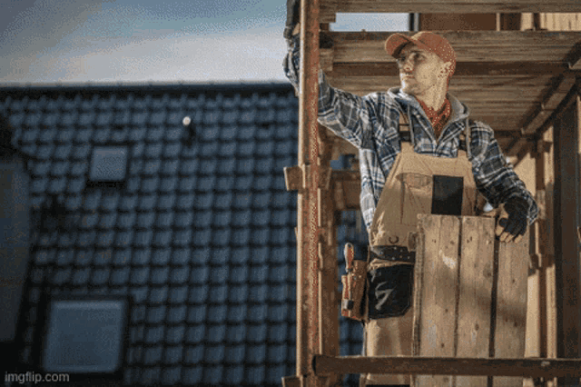a man is standing on a wooden scaffolding with the number 7 on his pocket