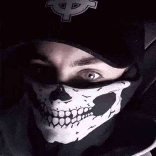 a man wearing a skull mask and a black hat