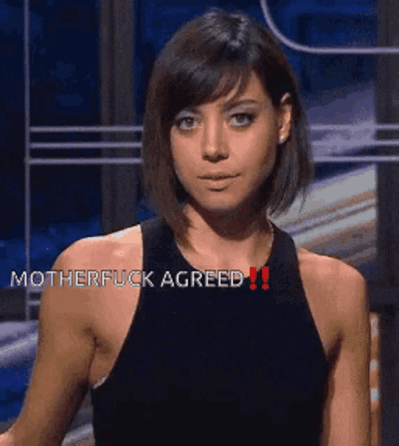 a woman in a black tank top with the words motherfuck agreed on her chest