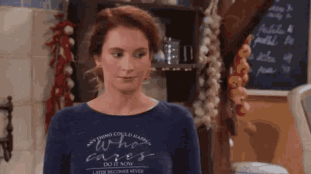 a woman wearing a blue shirt that says anything could happen who cares do it now